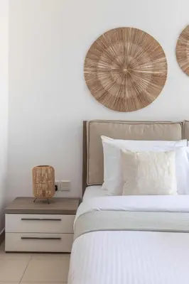a bedroom with a bed with a wooden nightstand next to it at Frank Porter - Aurora Tower, Dubai Marina in Dubai