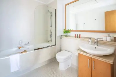 a bathroom with a sink and a toilet and a tub at Frank Porter - Aurora Tower, Dubai Marina in Dubai