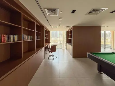 a room with a pool table and a library at Frank Porter - The Paragon in Dubai