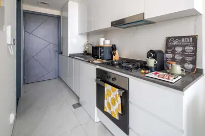 a kitchen with a stove and a counter top at Frank Porter - Samana Golf Avenue in Dubai