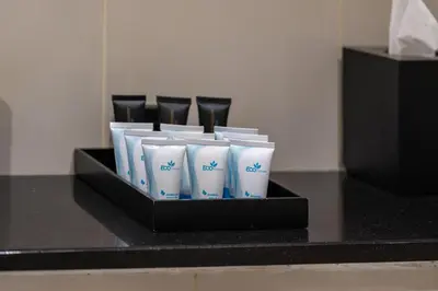 a group of white cups in a black box at DAMAC Maison Cour Jardin - Pool & Gym - Free Parking in Dubai
