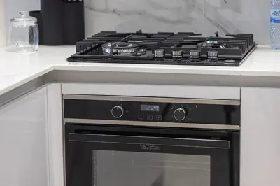 a stove top oven sitting in a kitchen at Deluxe Binghatti JVC Suites by Hostiva - City View in Dubai