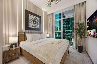 a bedroom with a large bed and a large window at Mahogany 20 - 1BR 4PAX - Infinity Pool & Spacious in Dubai