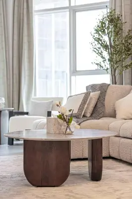 a living room with a coffee table in front of a couch at Mahogany 20 - 1BR 4PAX - Infinity Pool & Spacious in Dubai