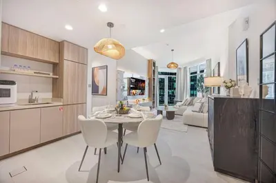 a kitchen and dining room with a table and chairs at Mahogany 20 - 1BR 4PAX - Infinity Pool & Spacious in Dubai