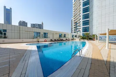 a large swimming pool in the middle of a building at StayShort - Premium 2BR in Dubai Marina - Sleeps 4 in Dubai