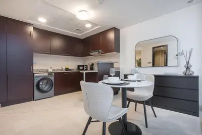 a kitchen and dining room with a table and chairs at StayShort - Extravagant Studio in DIFC with Skyline Views in Dubai