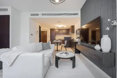 a living room with a white couch and a table at StayShort - Extravagant Studio in DIFC with Skyline Views in Dubai