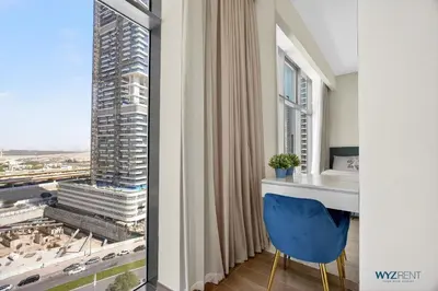 a room with a blue chair and a window at Spacious and Luxurious 2 BD in Downtown Sleeps 8 with Maid Room in Dubai