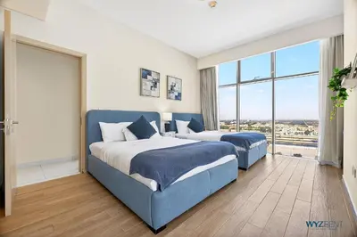 a bedroom with two beds and a large window at Spacious and Luxurious 2 BD in Downtown Sleeps 8 with Maid Room in Dubai