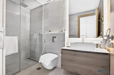 a bathroom with a shower and a toilet and a sink at Spacious and Luxurious 2 BD in Downtown Sleeps 8 with Maid Room in Dubai