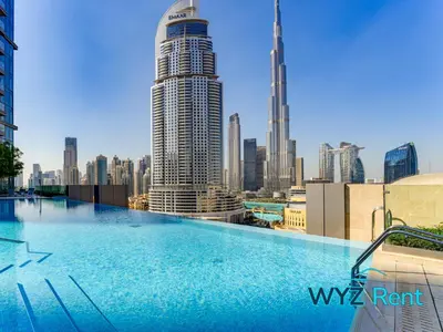 a swimming pool on the roof of a building with a city at Iconic 4BR with Burj & Fountain Views Boulevard Point in Dubai