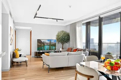 a living room with a couch and a table at Iconic 4BR with Burj & Fountain Views Boulevard Point in Dubai