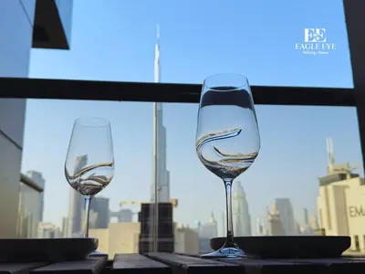 two wine glasses sitting on a table in front of a window at Spacious 1 Bed with Burj Khalifa View accommodates 3 or 4 in Dubai