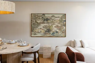 a living room with a large painting on the wall at Maison Privee - Chic Downtown Living with Dubai Cityscape Views in Dubai
