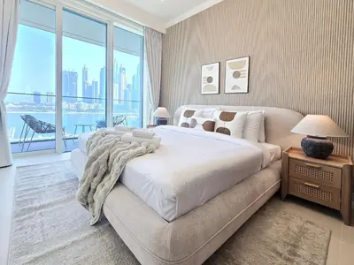 a bedroom with a large bed and a large window at Venduras- 2BR Retreat , Beach Access , Emaar Beachfront in Dubai