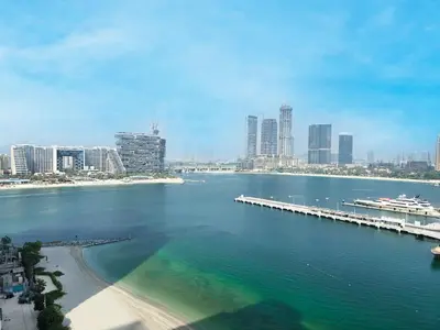 a large body of water with a pier and a city at Venduras- 2BR Retreat , Beach Access , Emaar Beachfront in Dubai