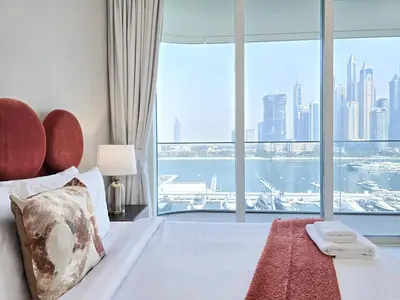 a hotel room with a bed with a large window at Venduras- 2BR Retreat , Beach Access , Emaar Beachfront in Dubai