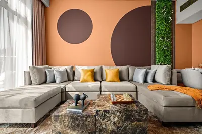 a living room with a couch and a table at Downtown Luxury 2 Bedroom Apartment with Iconic Burj Khalifa Views, Rooftop Pool, Movie Room, Squash Court, and Kids Club in Dubai