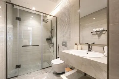 a bathroom with a shower and a sink and a toilet at Trophy Soft tones sharp style Masterpiece 705 in Dubai