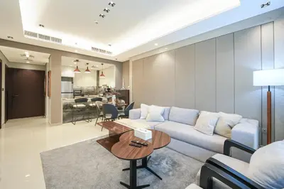 a living room with a couch and a table at Trophy Soft tones sharp style Masterpiece 705 in Dubai