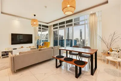 a living room with a couch and a table at Modern 2 Bed with Waterfront Views, Gym & Pool in Dubai