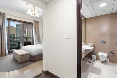 a hotel room with a bed and a bathroom at Stylish 1-Bedroom with Balcony & Amenities in Marina in Dubai