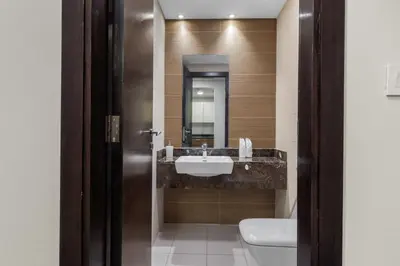 a bathroom with a sink and a toilet at Stylish 1-Bedroom with Balcony & Amenities in Marina in Dubai