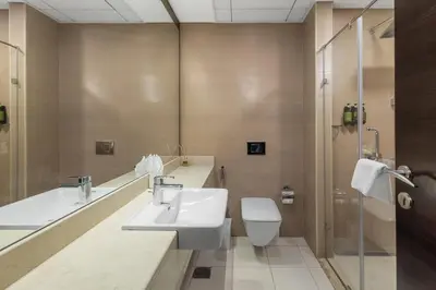 a bathroom with a sink and a toilet and a shower at Stylish 1-Bedroom with Balcony & Amenities in Marina in Dubai