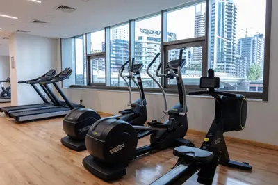 a gym with treadmills and ellipticals in a building at Stylish 1-Bedroom with Balcony & Amenities in Marina in Dubai
