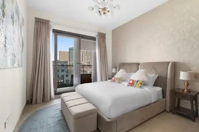 a bedroom with a bed and a large window at Stylish 1-Bedroom with Balcony & Amenities in Marina in Dubai