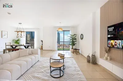 a living room with a white couch and a table at 1 Br Boho Beach Ain Full Sea View JBR 1 min in Dubai