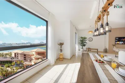 a dining room with a large window with a view of the ocean at 1 Br Boho Beach Ain Full Sea View JBR 1 min in Dubai