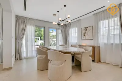 a dining room with a table and chairs at Brand new Large Villa JVT Private Garden in Dubai