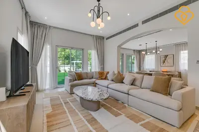 a living room with a couch and a tv at Brand new Large Villa JVT Private Garden in Dubai