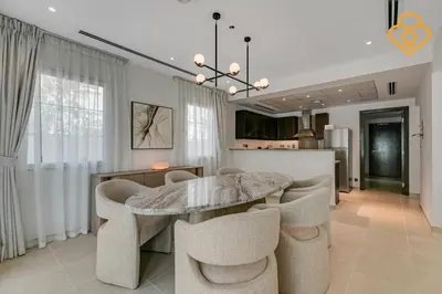 a dining room with a marble table and chairs at Brand new Large Villa JVT Private Garden in Dubai