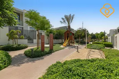 a park with a slide and a playground at 3 BR W Maid Walk to Pool, Arabian Ranches III Ruba in Dubai