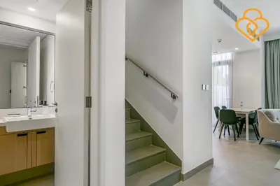 a staircase in a bathroom with a sink and a table at 3 BR W Maid Walk to Pool, Arabian Ranches III Ruba in Dubai