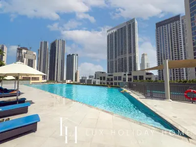 a swimming pool on the roof of a building with tall buildings at LUX The Creekside Skyline View Suite in Dubai