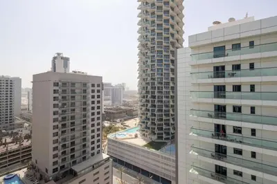 a view of two tall buildings in a city at Frank Porter - Empire Residence, JVC in Dubai