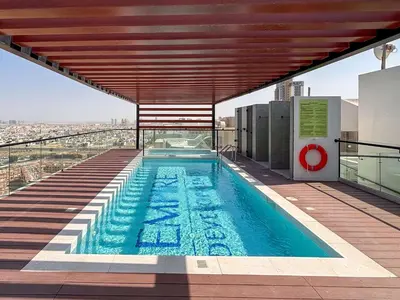 a swimming pool on the roof of a building at Frank Porter - Empire Residence, JVC in Dubai