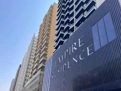 a tall building with the words exchange real estate at Frank Porter - Empire Residence, JVC in Dubai