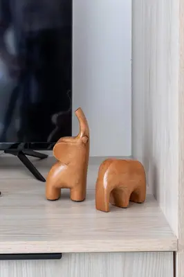 two wooden animals sitting on top of a shelf at Frank Porter - Empire Residence, JVC in Dubai