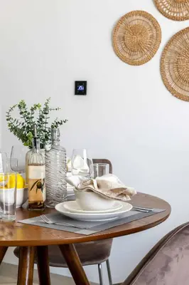 a wooden table with a plate of food on it at Frank Porter - Empire Residence, JVC in Dubai