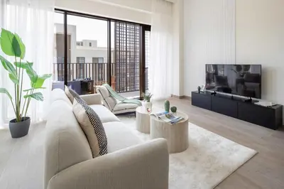 a living room with a couch and a tv at Frank Porter - Lotus at Creek Beach in Dubai