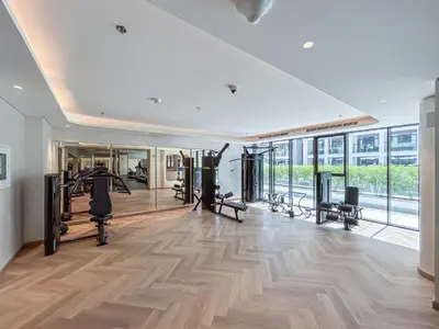 a gym with treadmills and exercise equipment in a building at Elegant & Cozy Home with Stylish Modern Interiors in Dubai
