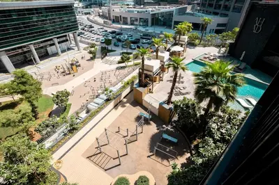 an overhead view of a city street with a pool at FIRST CLASS Studio Modern Elegance in Dubai