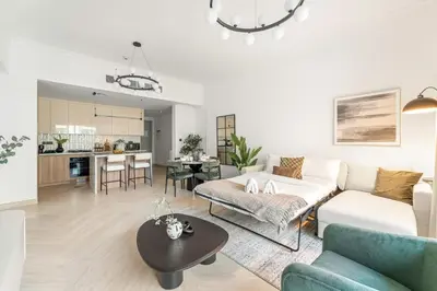 a living room with a couch and a table at FIRST CLASS 1BR Canal Views , Gem of Mayfair in Dubai