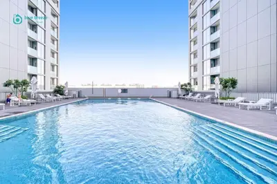a large swimming pool in the middle of a building at Blue Breeze - 2 Bedroom near Downtown, Elegant Retreat in Sobha in Dubai