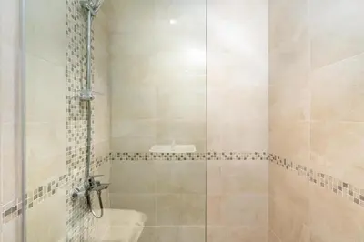 a bathroom with a shower with a glass door at Ahlan HH - 1BR Haven with Study Room - Eleganz by Danube in Dubai